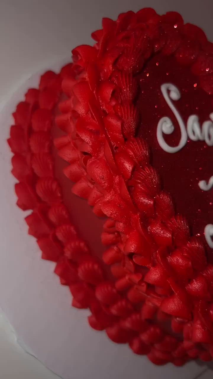 This may contain: there is a heart shaped cake with the name sara on it