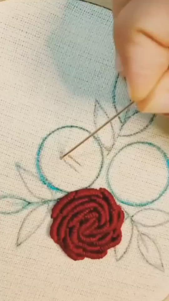 This may contain: a close up of a embroidery with two roses on it