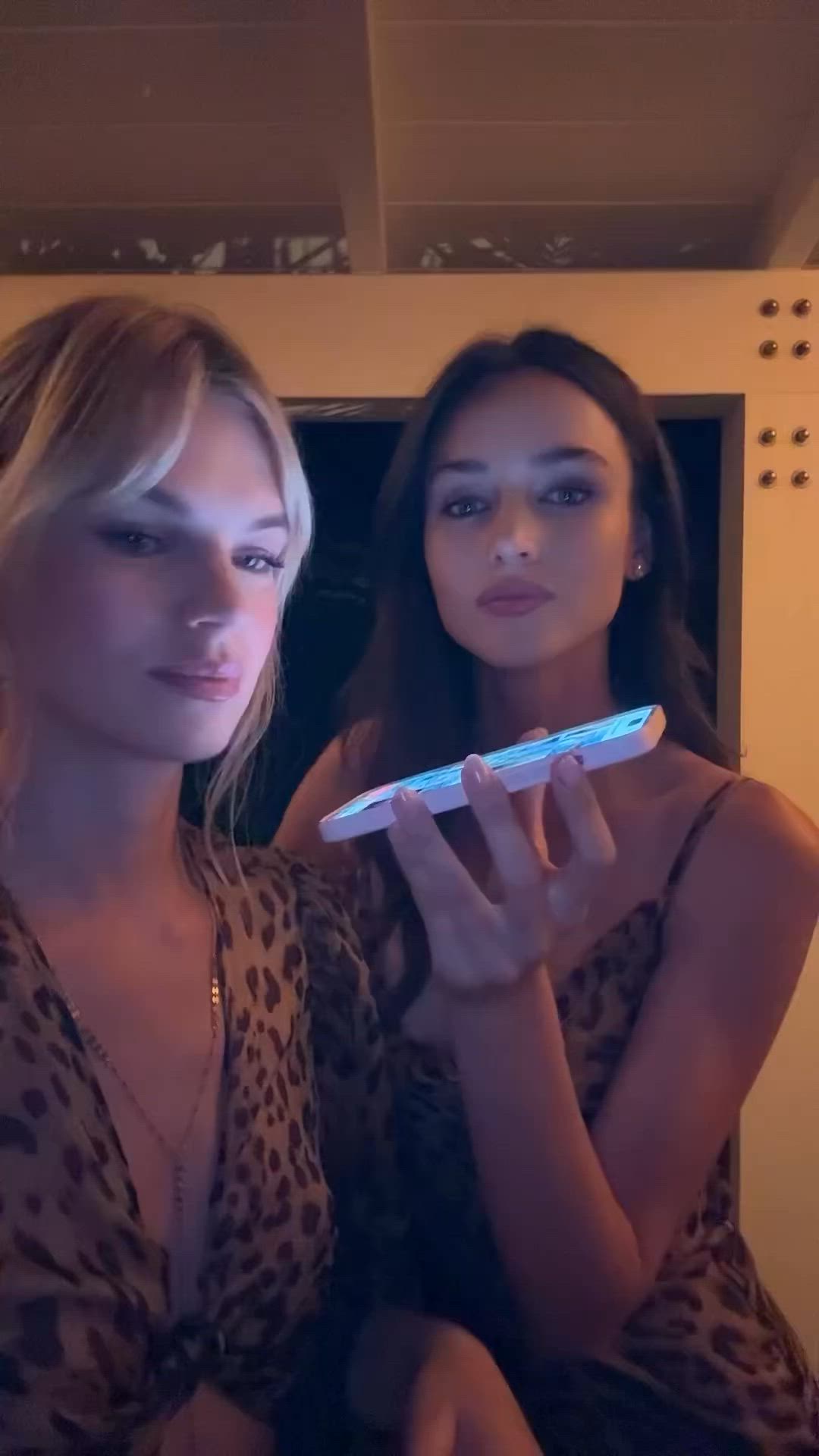 This may contain: two beautiful young women standing next to each other holding a toothbrush in their hands