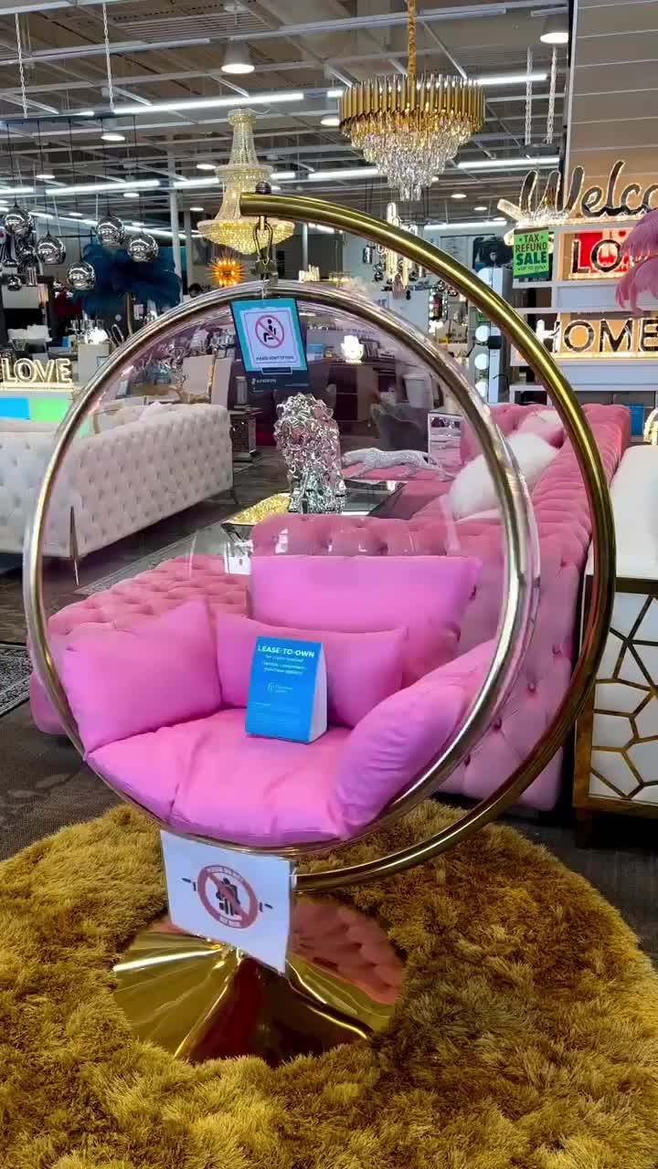 This may contain: a pink chair sitting on top of a rug in a store