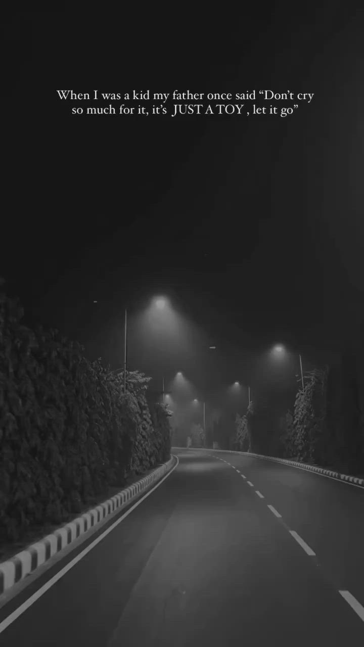 This may contain: an empty road at night with street lights on the side and a quote written below