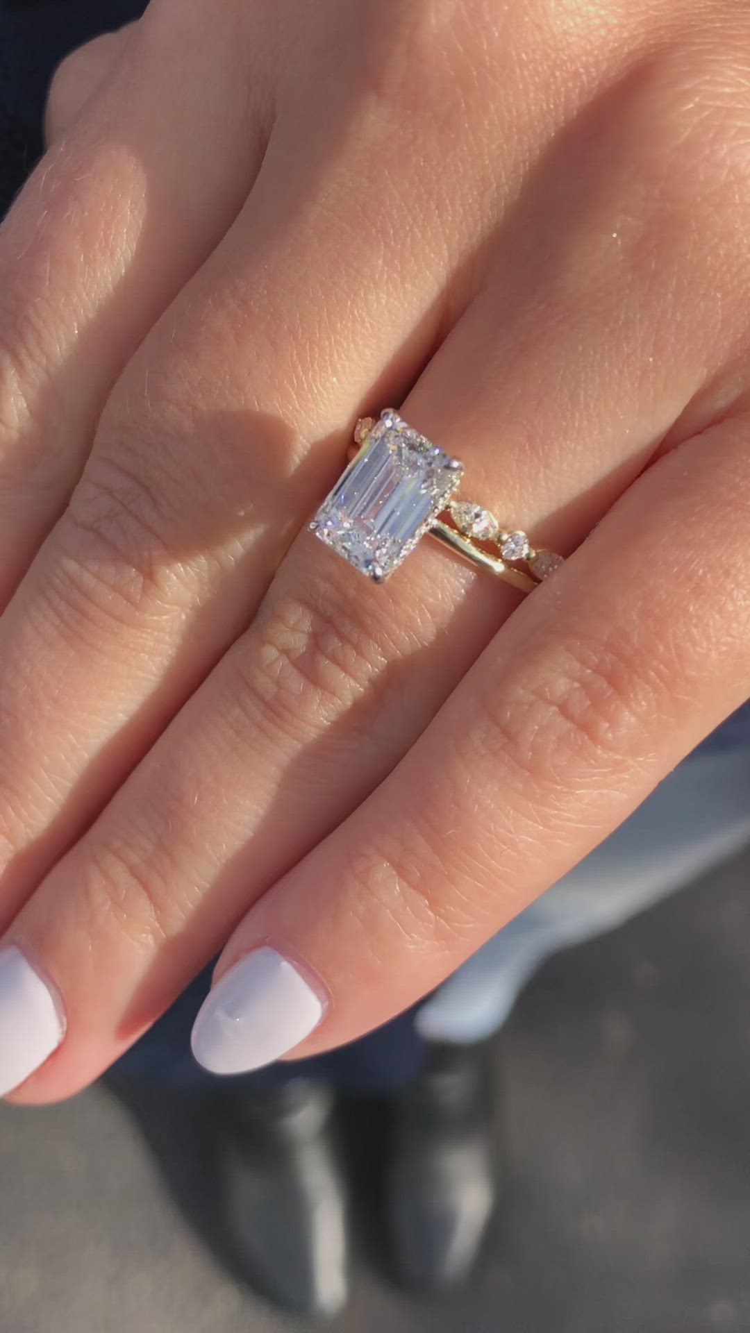 This may contain: a woman's hand with a diamond ring on it