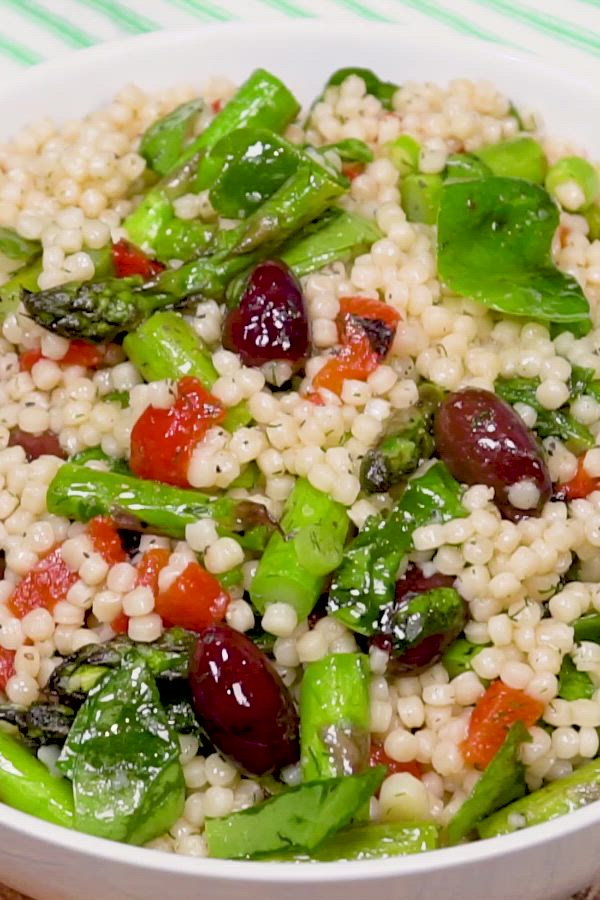 This may contain: a white bowl filled with rice and vegetables