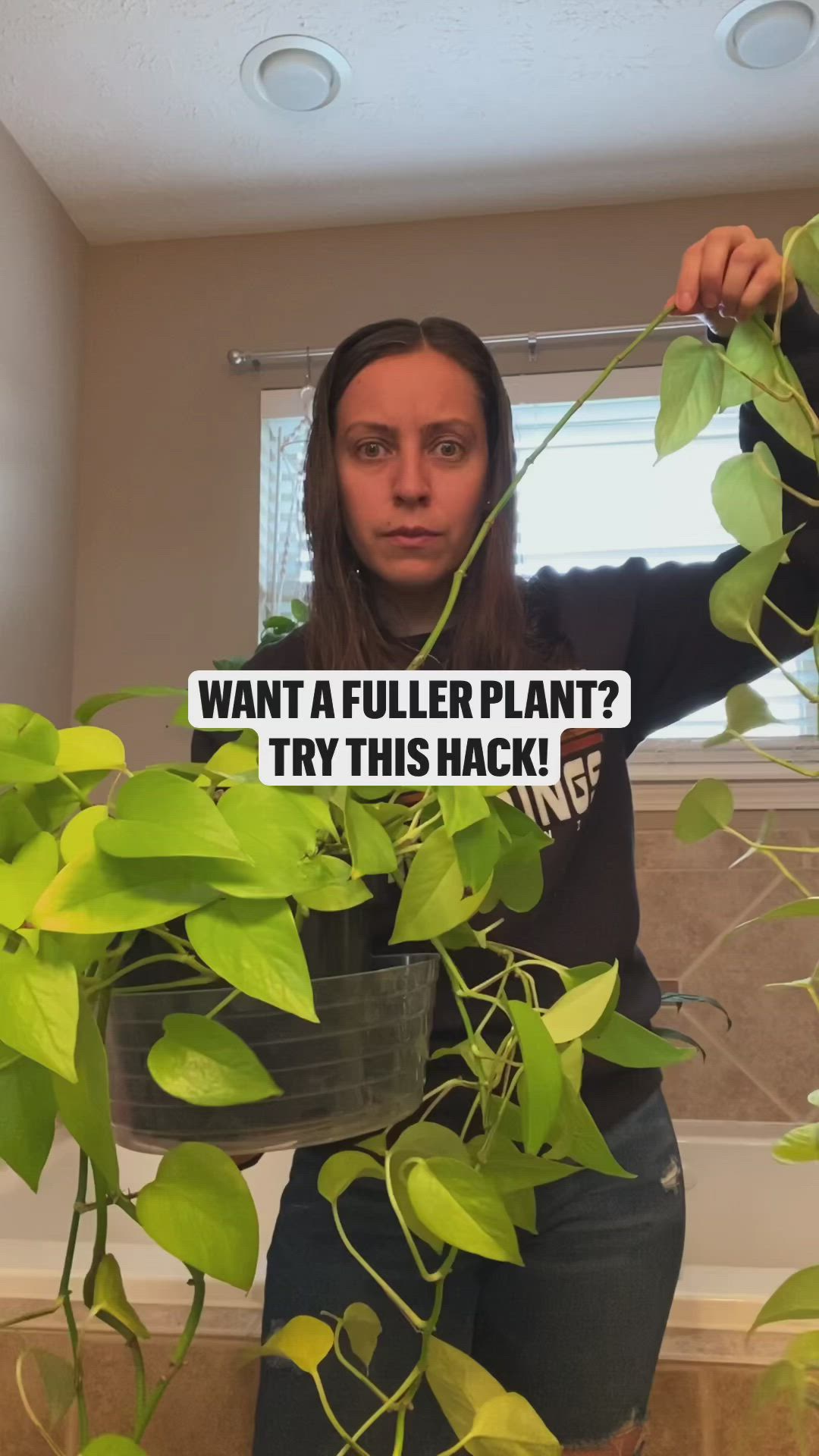 This may contain: a woman standing in front of a potted plant with the caption, want a flower plant? try this hack