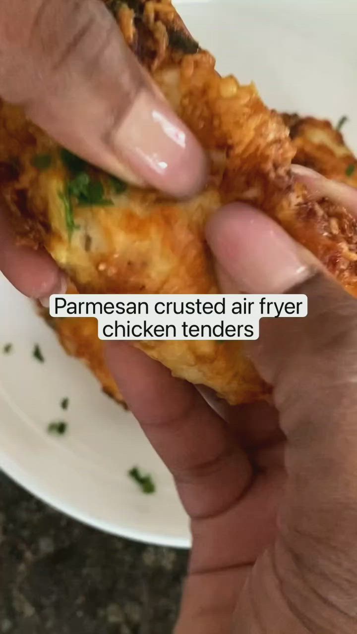 This may contain: two pieces of chicken with parmesan crusted air fryer