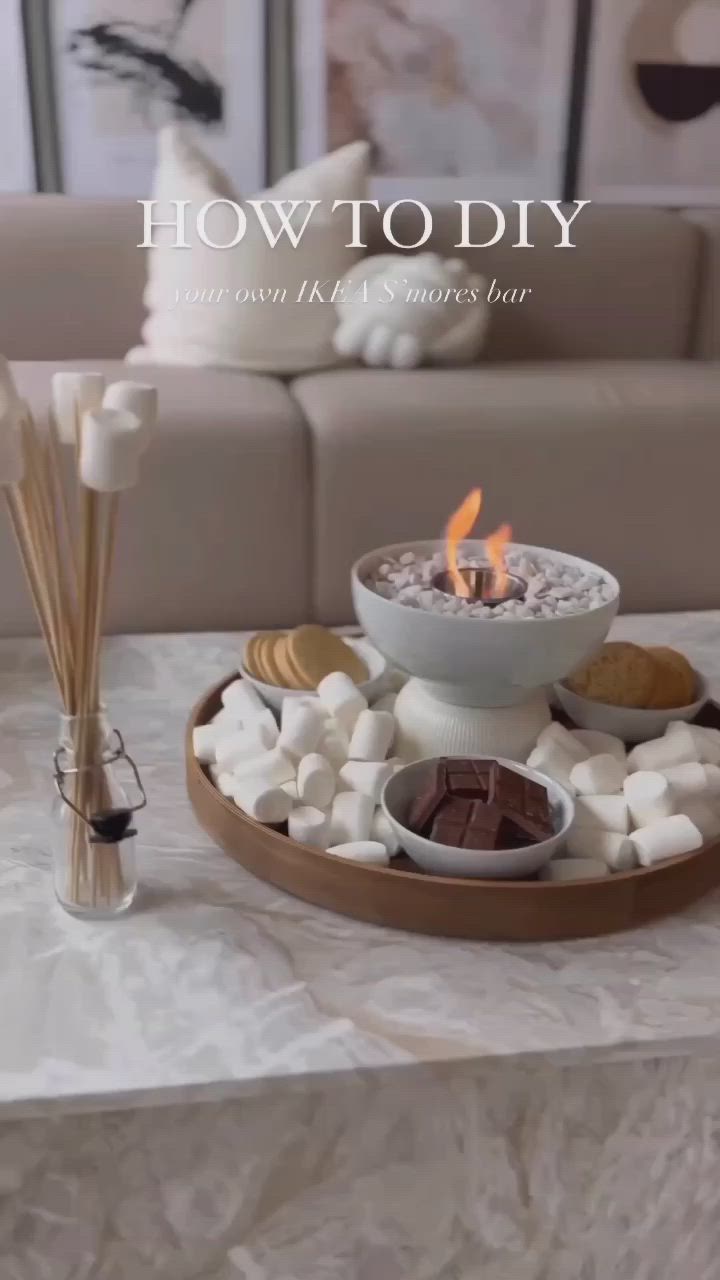 This may contain: a table topped with marshmallows and candles