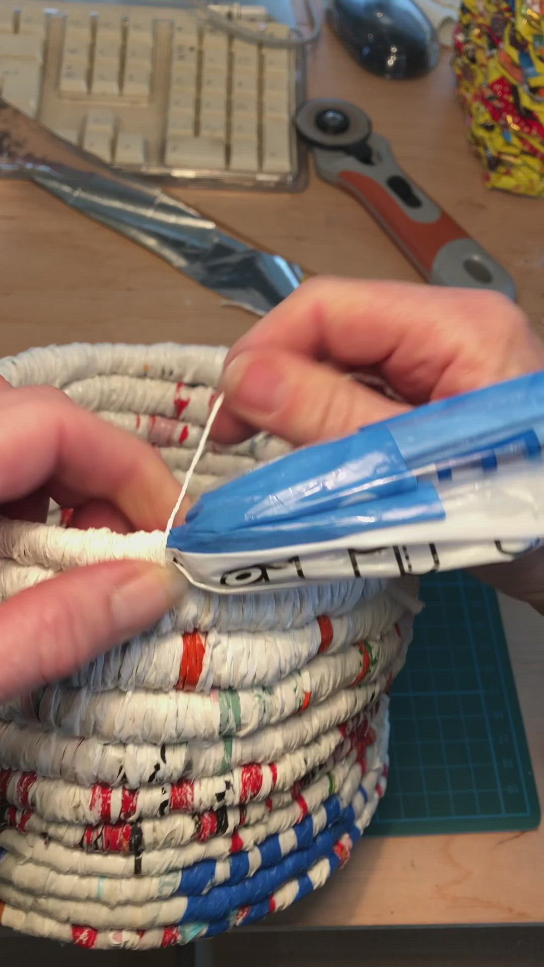 This may contain: a person cutting fabric with scissors on a table