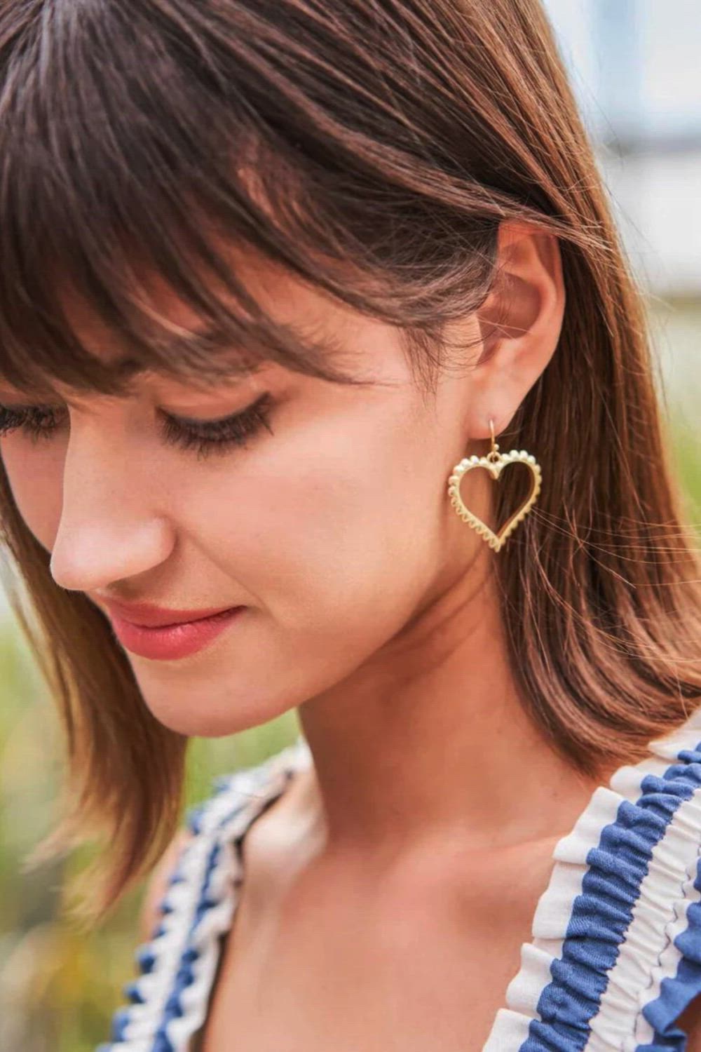 Add a whisper of romance to your everyday look with our Scalloped Heart Earrings, exquisitely crafted in 18kt matte gold plating. These lightweight, beautifully designed earrings feature delicate scalloped edges that frame your face with elegance and grace. Perfect for any occasion, they're not just accessories but a reminder to always follow your heart. #chicjewelry #heartshapedearrings #mattegoldearrings #romanticjewelry #elegantaccessories