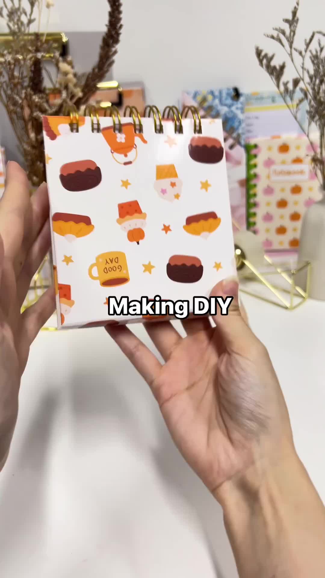 This may contain: a hand holding a planner with the words making diy meal planner on it