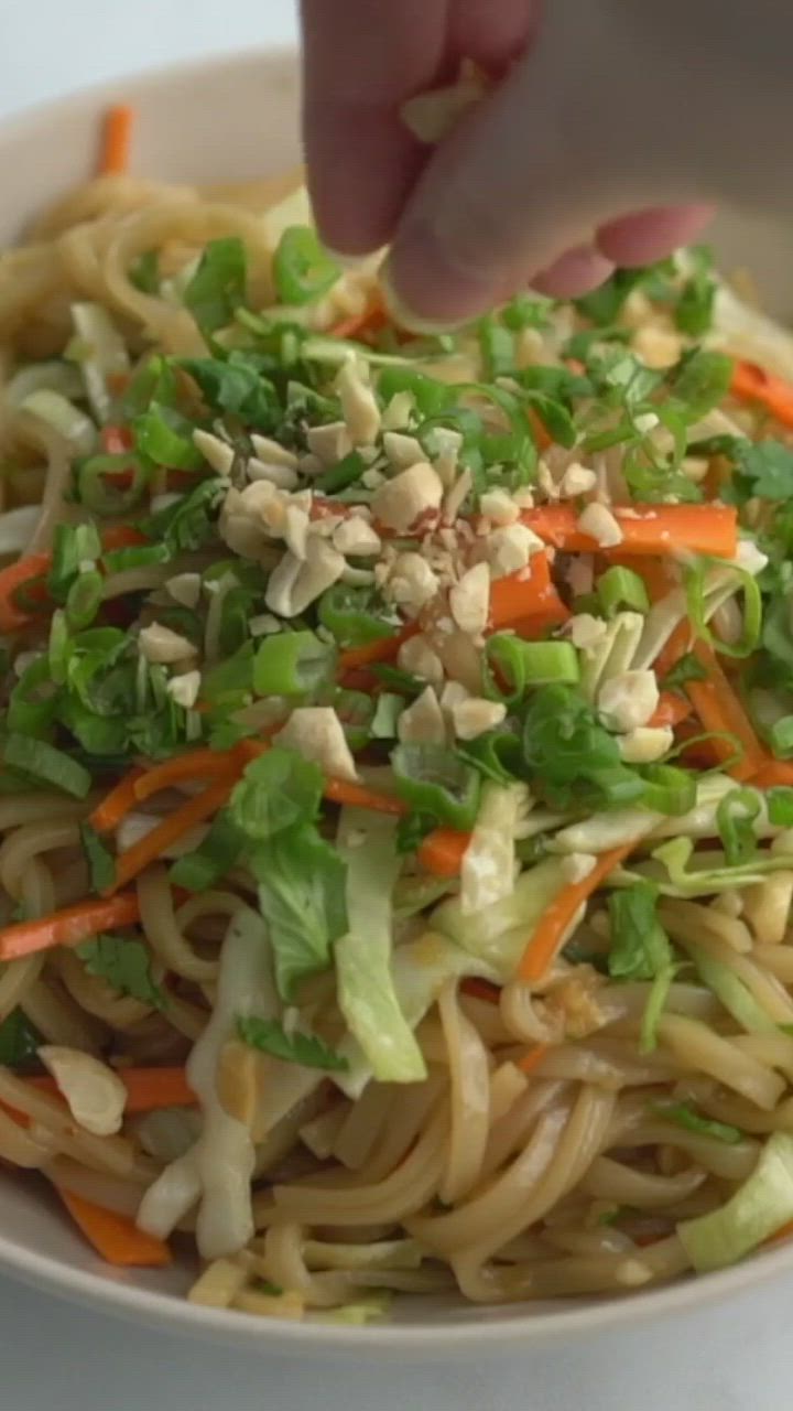 This may contain: a bowl filled with noodles, carrots and lettuce next to the words quick & easy thai noodle bowl