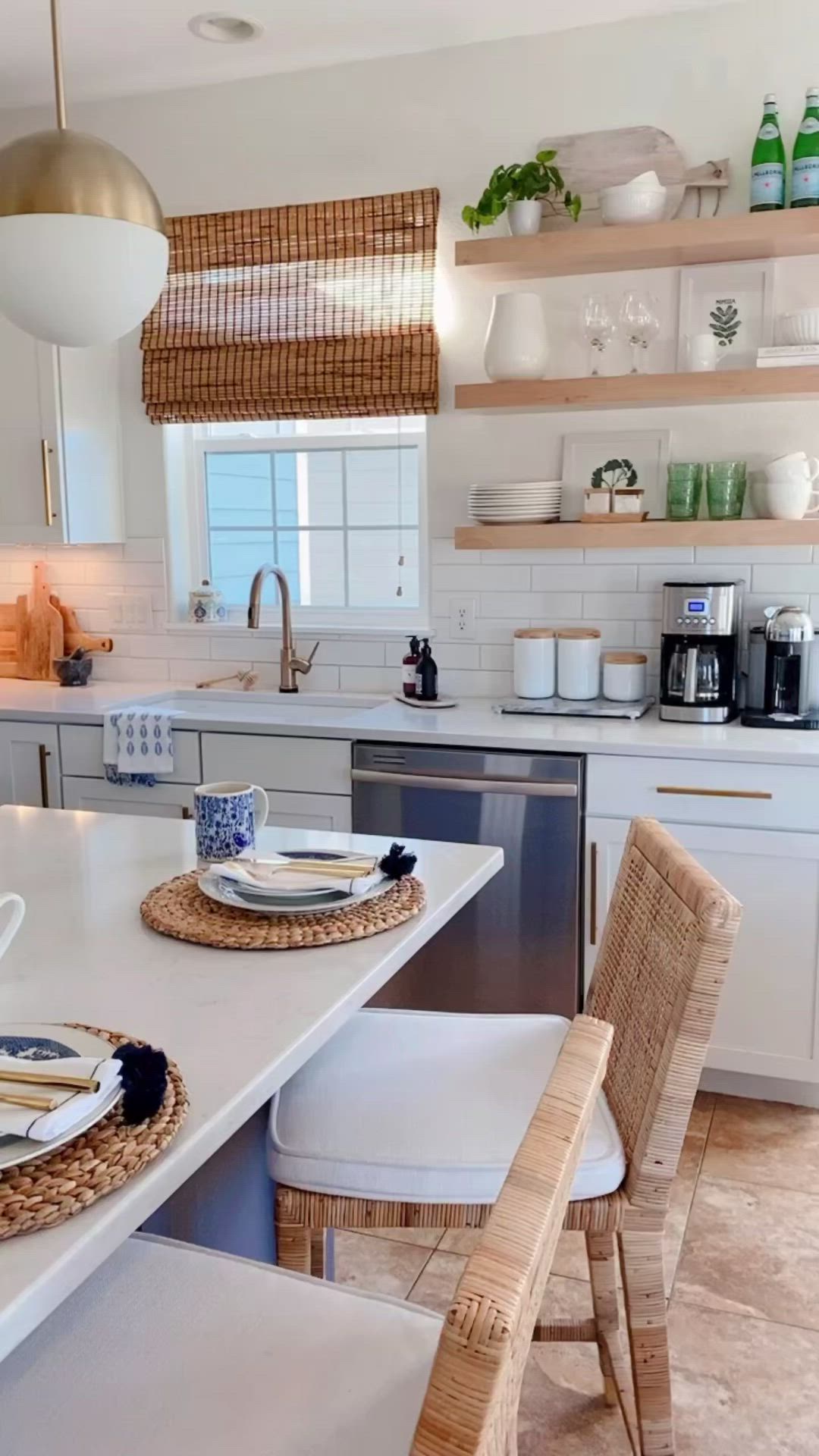 This may contain: a kitchen with white counter tops and wooden shelves filled with dishes on top of it