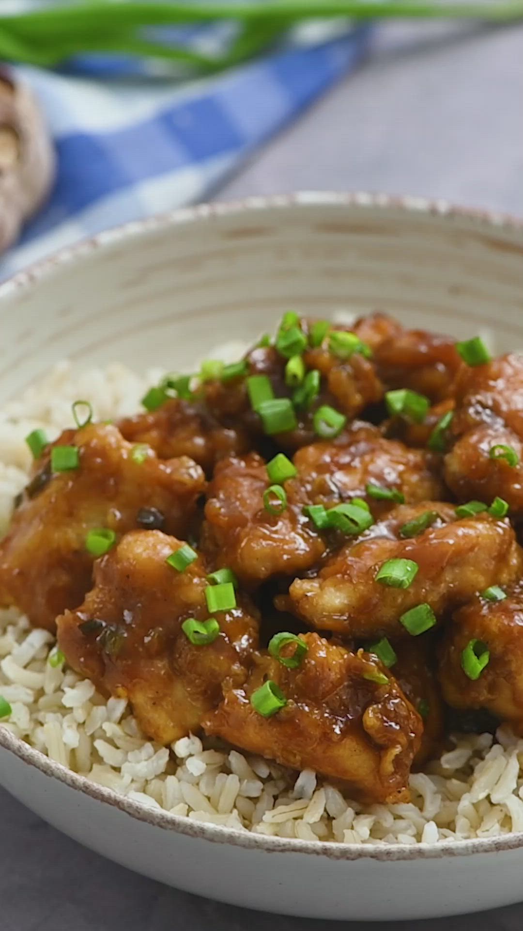 This may contain: a close up of a plate of food with rice and chicken on it, with the words slow cooker orange chicken