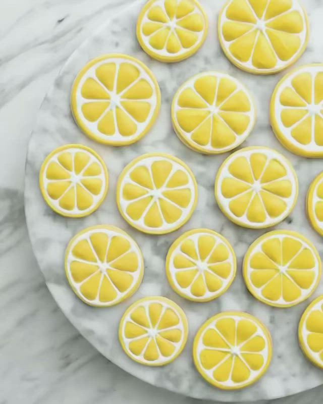 This may contain: lemon slices are arranged on a marble platter