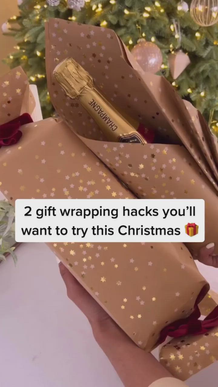 This may contain: someone is holding two wrapped gifts in front of a christmas tree with the text, 2 gift wrapping hacks you'll want to try this christmas