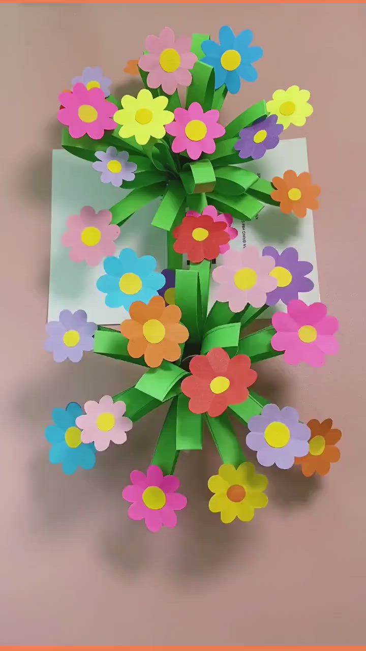 This may contain: an origami flower bouquet made out of paper on a pink background with the words,