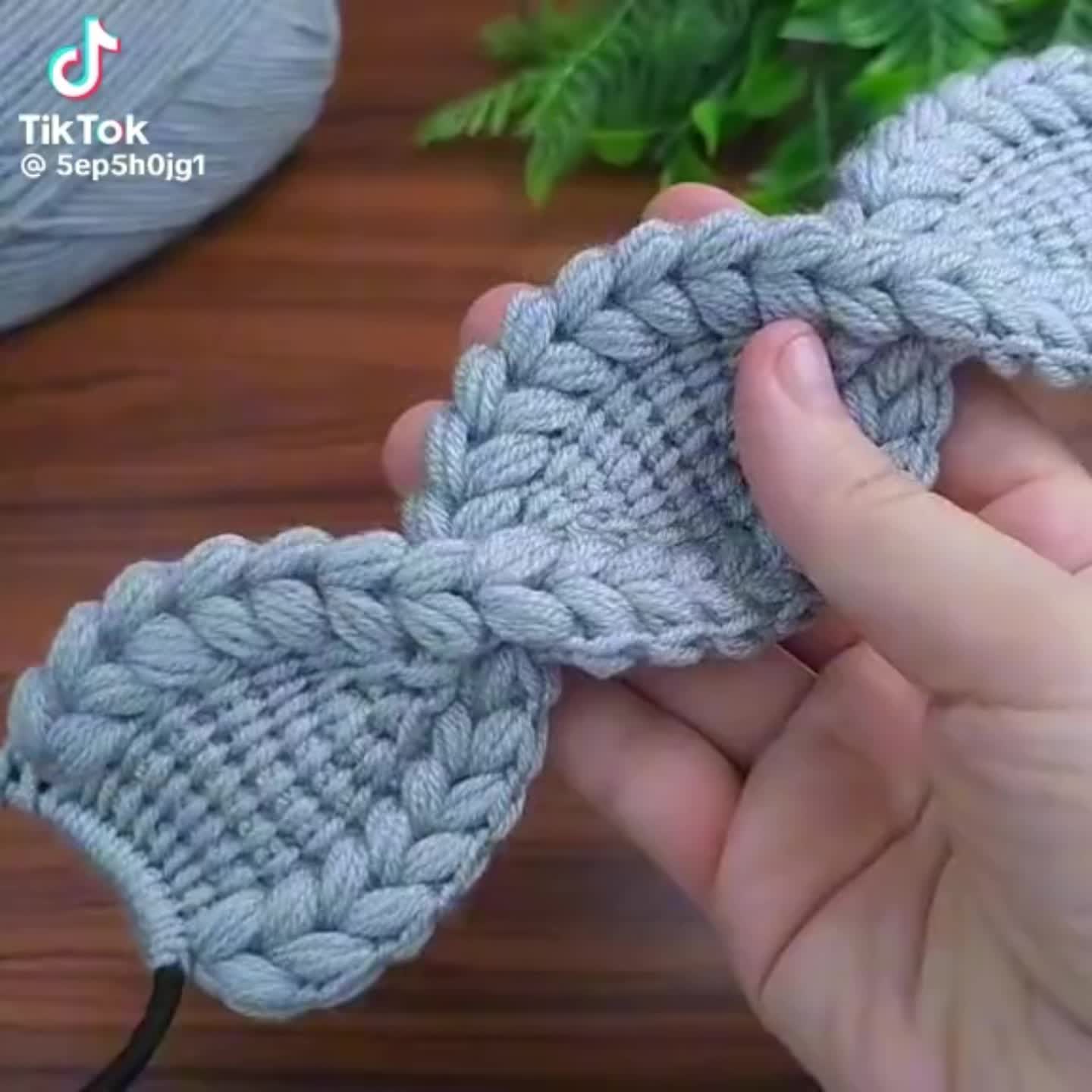 This may contain: someone is crocheting a knot on a piece of yarn that looks like an ornament