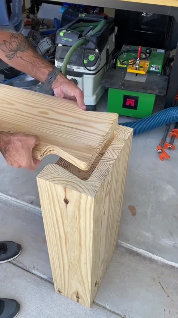 This may contain: a man working on a piece of wood