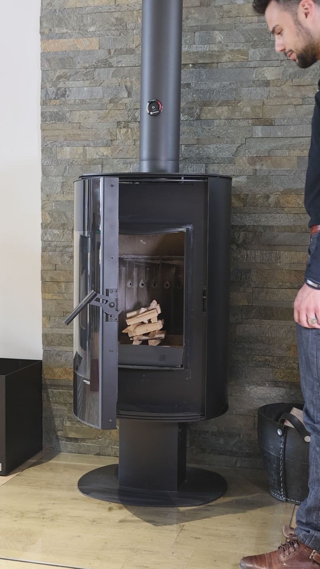 This may contain: a man standing in front of a wood burning stove