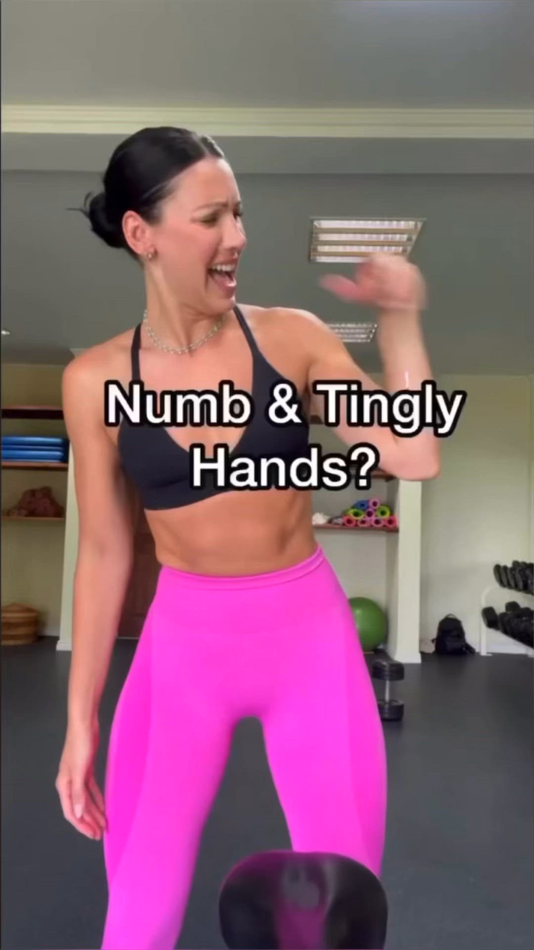 This may contain: a woman in pink leggings and black bra top with the words numb & tingly hands?