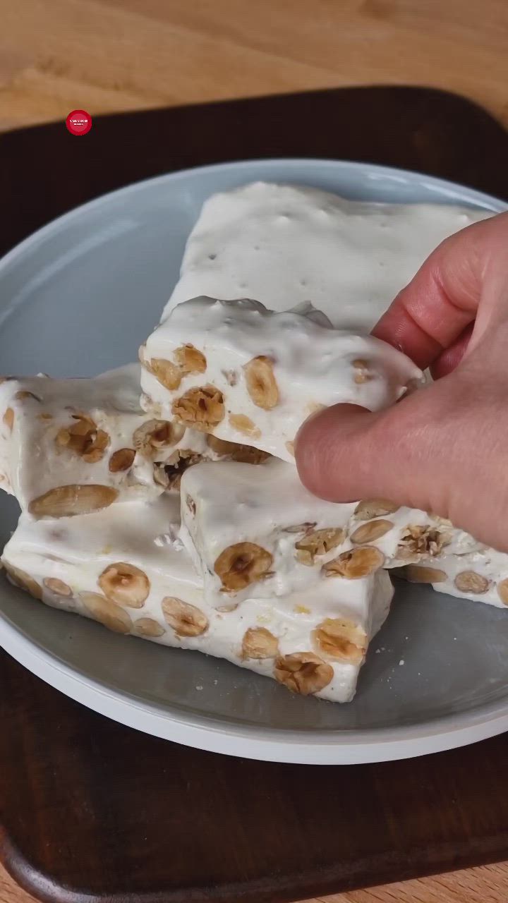 This may contain: a person is holding onto some food on a white and gray plate with brown trim