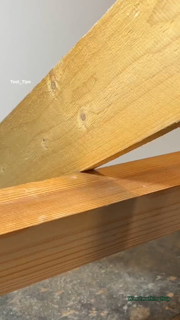 This may contain: a wooden bench sitting on top of a cement floor