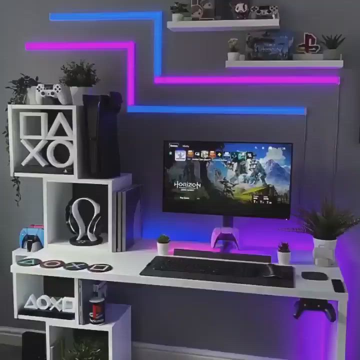 This may contain: a desk with a computer on it in front of some shelves and purple lighting above