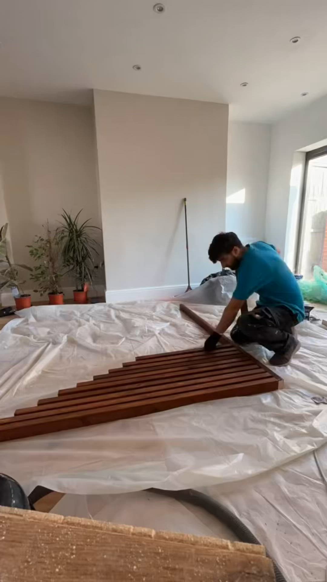 This may contain: a man working on some wood in a room