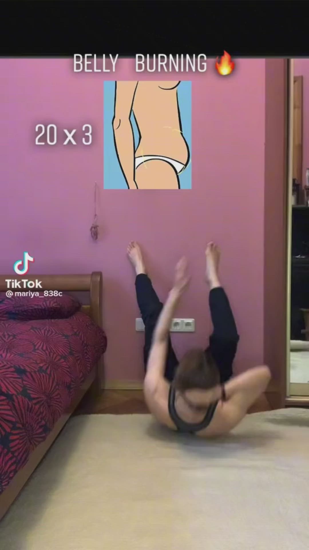 This may contain: a woman is doing yoga on the floor in front of a bed with her legs up