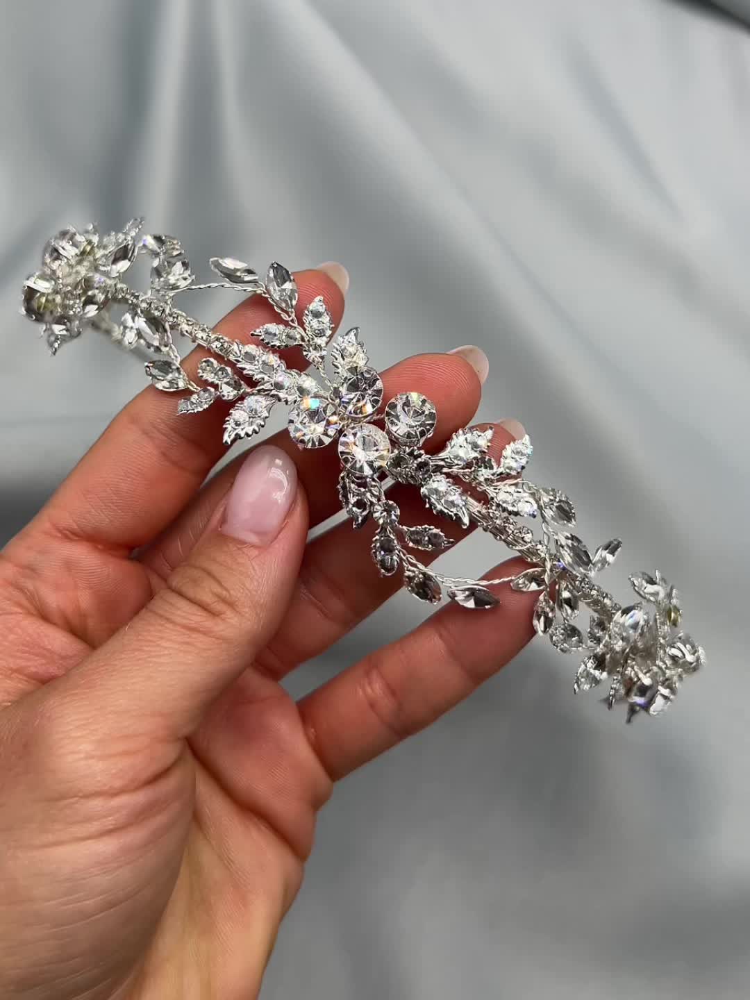 Ethereal & glamorous, our Rylee Floral Headband will sparkle from all angles in your wedding hair. Crafted with hand wired vines of crystals & jeweled leaves for a floral feel. Crystals & leaves Measures 1" at the widest point Pin loops are located at each end to secure to hair with bobby pins Style #3445