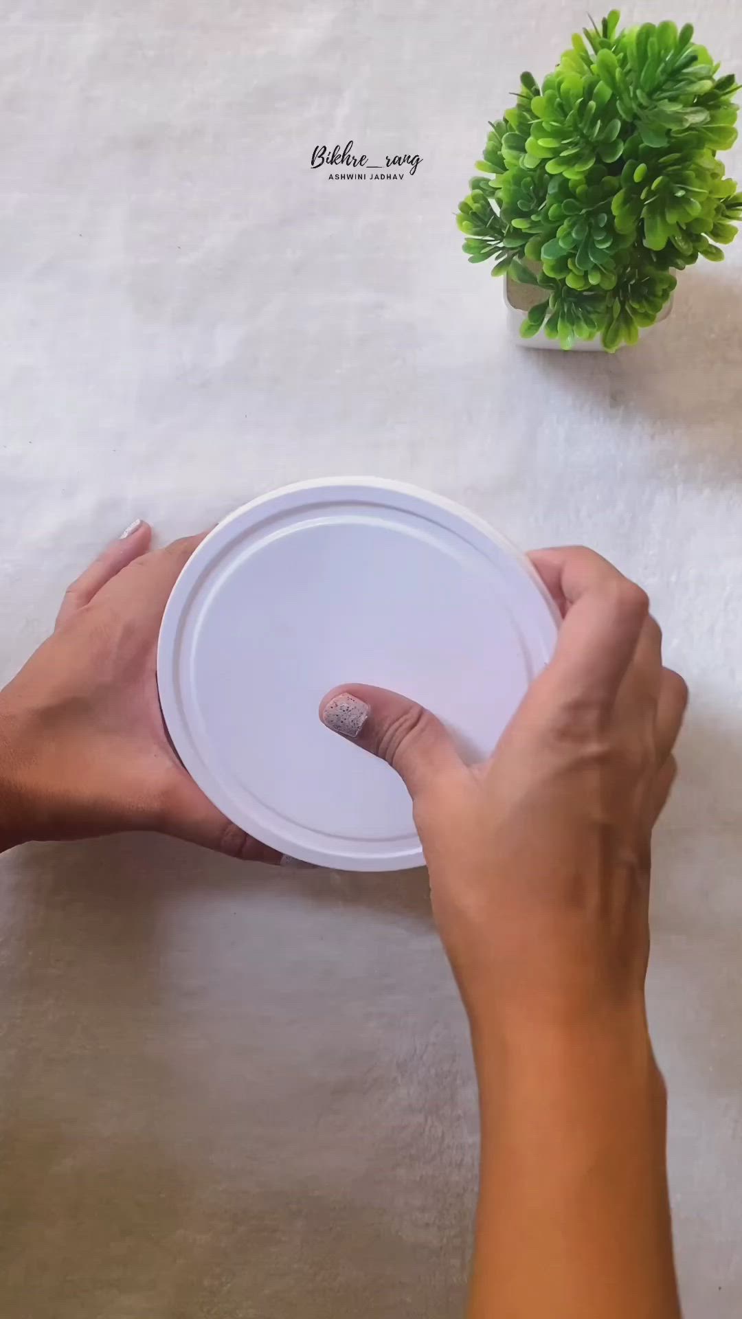 This may contain: three frisbees with tassels attached to them sitting on a table