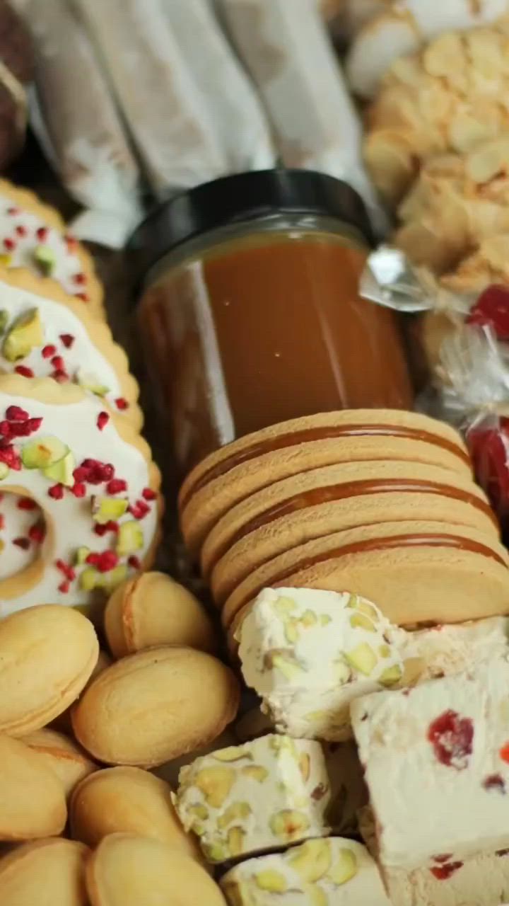 This may contain: a wooden box filled with lots of different types of cookies