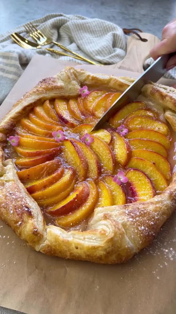 This may contain: there is a pie that has peaches on it