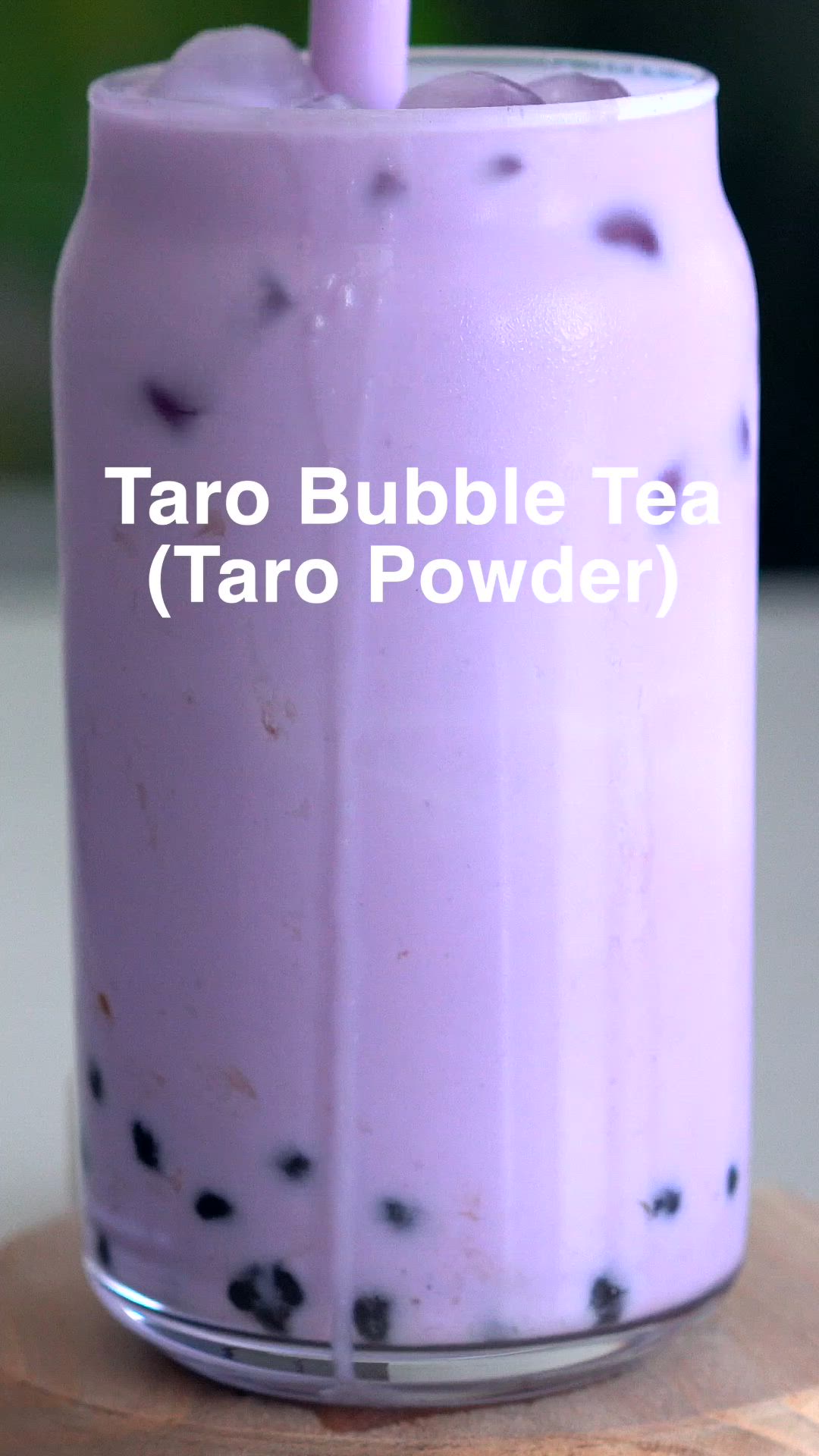 This may contain: a purple bubble tea in a mason jar