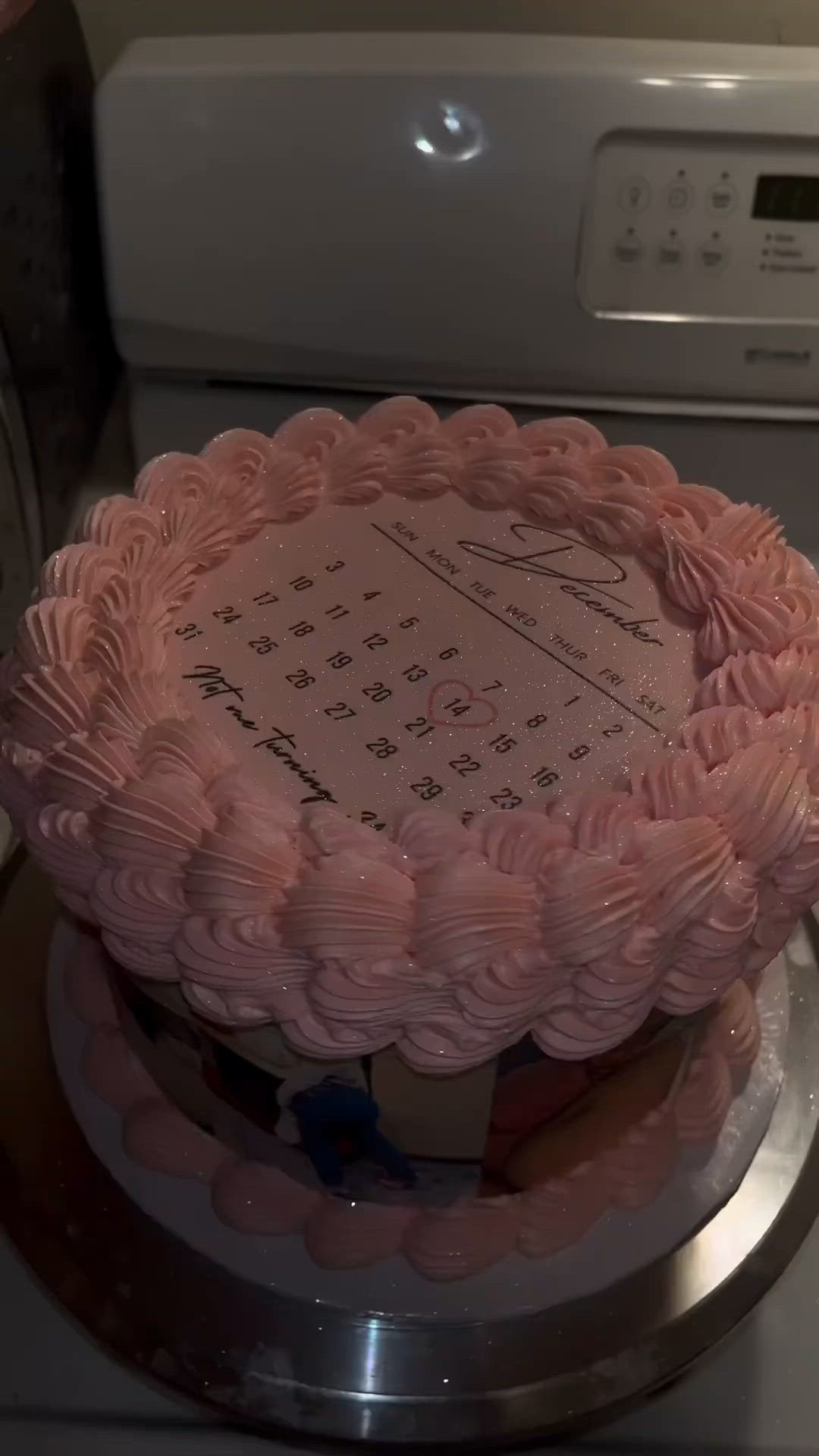 This may contain: a pink cake sitting on top of a stove