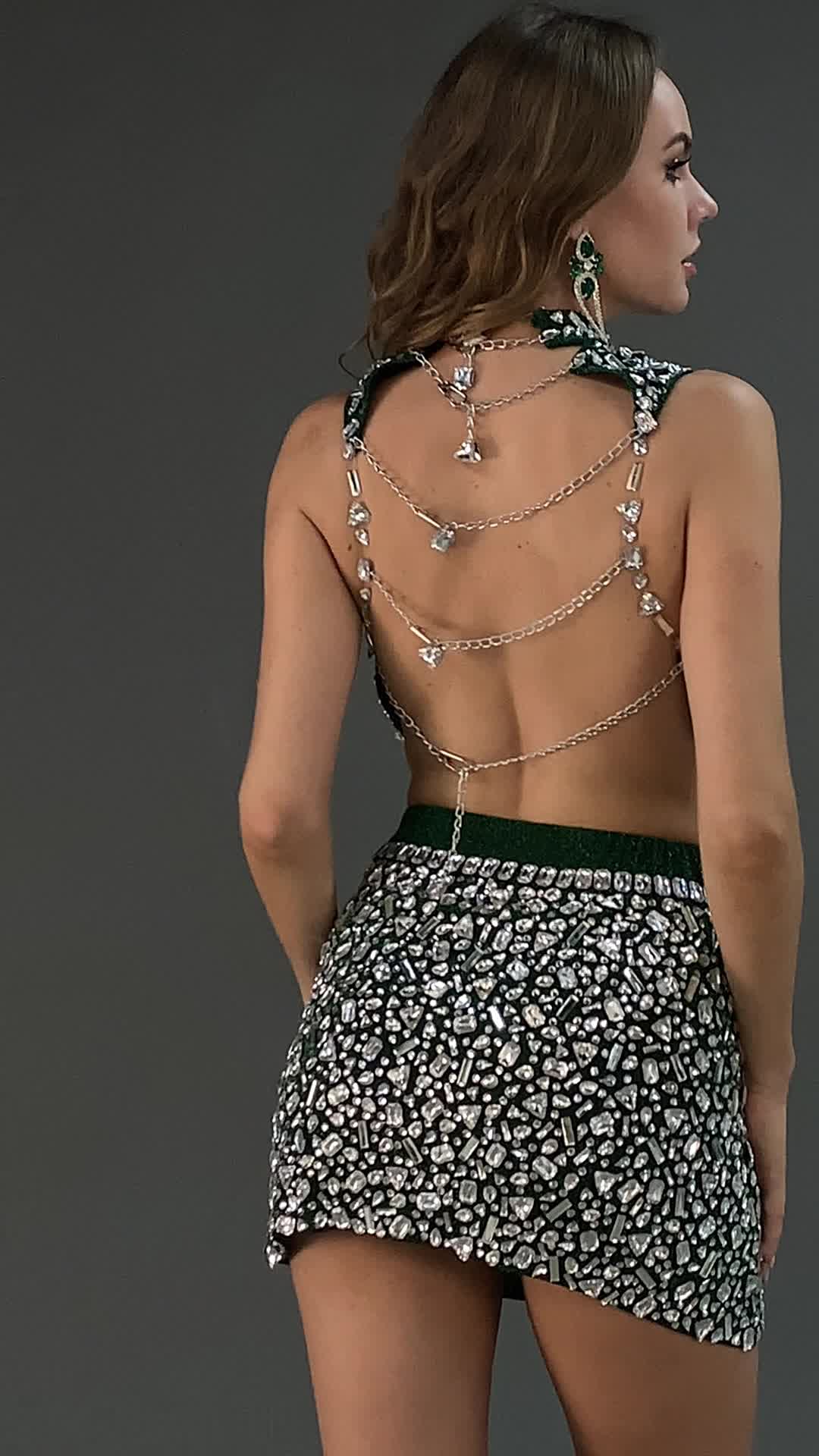 Elevate your style with the Saleas High Neck Diamond Backless Set. This stunning ensemble features a high neck adorned with dazzling diamond details, and a backless design connected by adjustable chains for a custom fit. The sleeveless top pairs perfectly with the matching short skirt, creating a sleek and sophisticated look. Ideal for upscale events, glamorous parties, or a night out, this set promises to make you the center of attention and exude confidence.