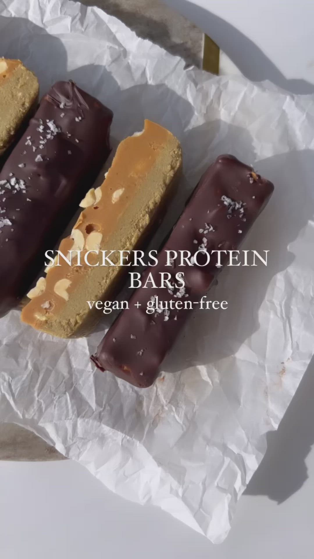 This may contain: three different types of desserts sitting on top of a piece of wax paper with the words, snickkers protein bars vegan + glutter - free