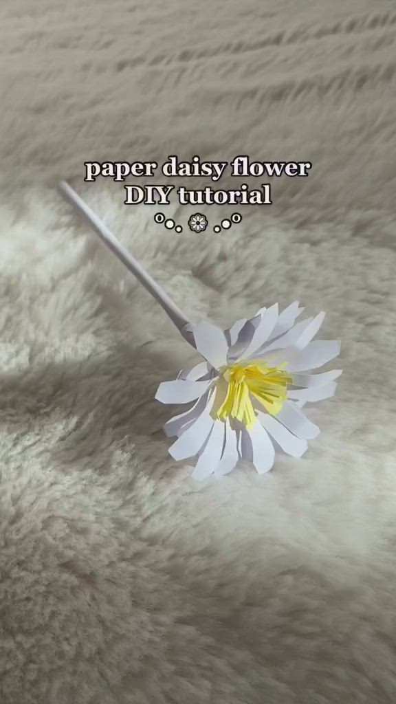 This contains: Discover how to create colorful paper daisy flowers with this easy DIY craft project for kids.