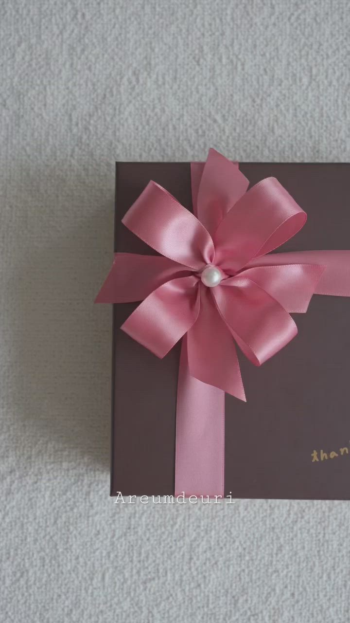 This may contain: a card with a pink bow on it