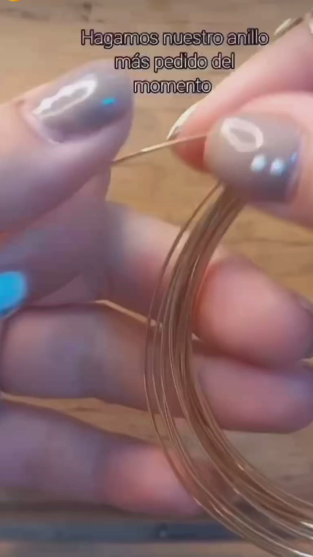 This may contain: a pair of scissors cutting through a ring with colored stones on it's side