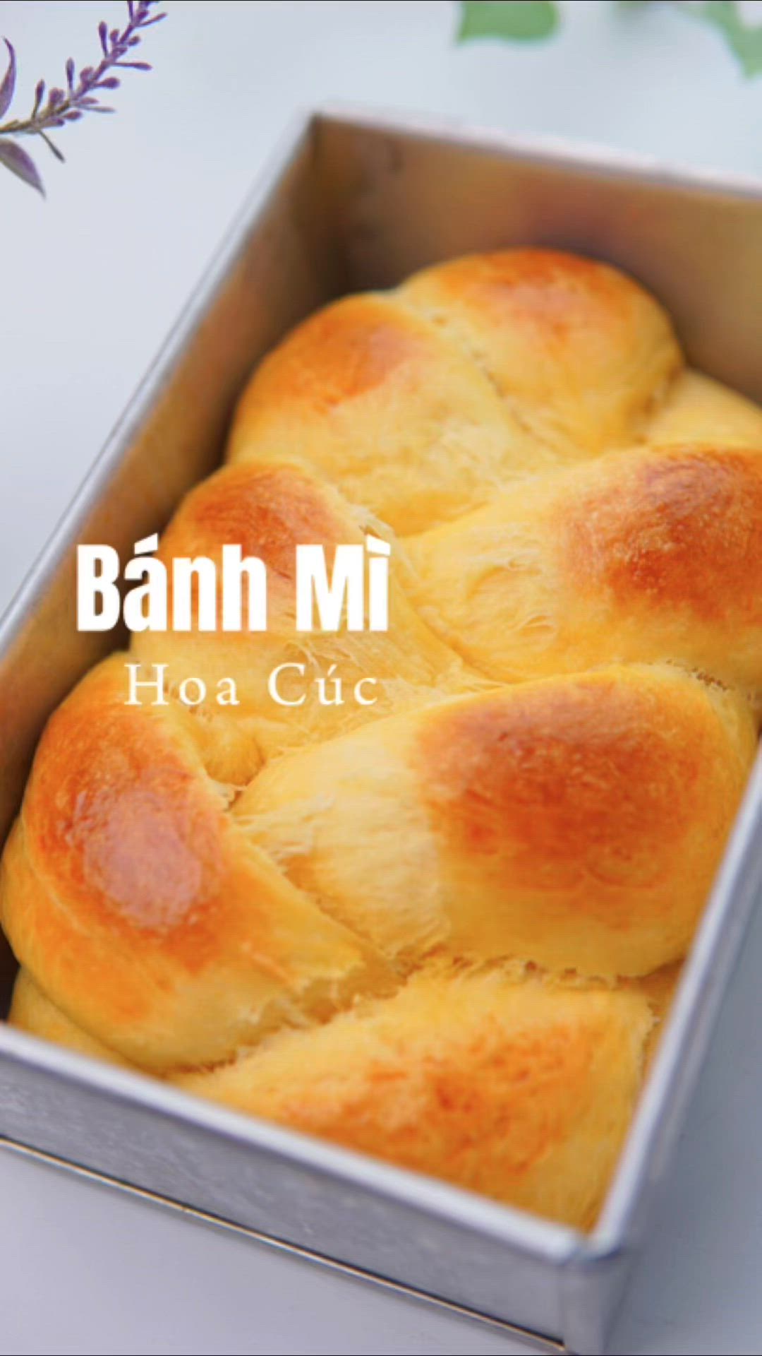 This may contain: baked bread in a tin with the words banh mi hoa cuc