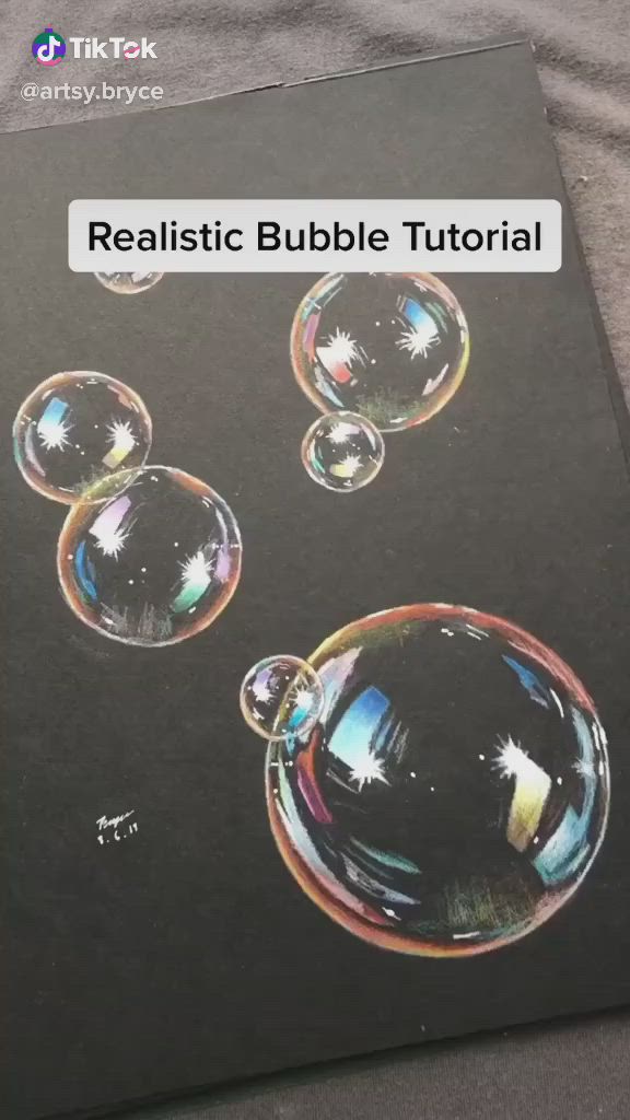 This may contain: a book with bubbles on it sitting on top of a bed