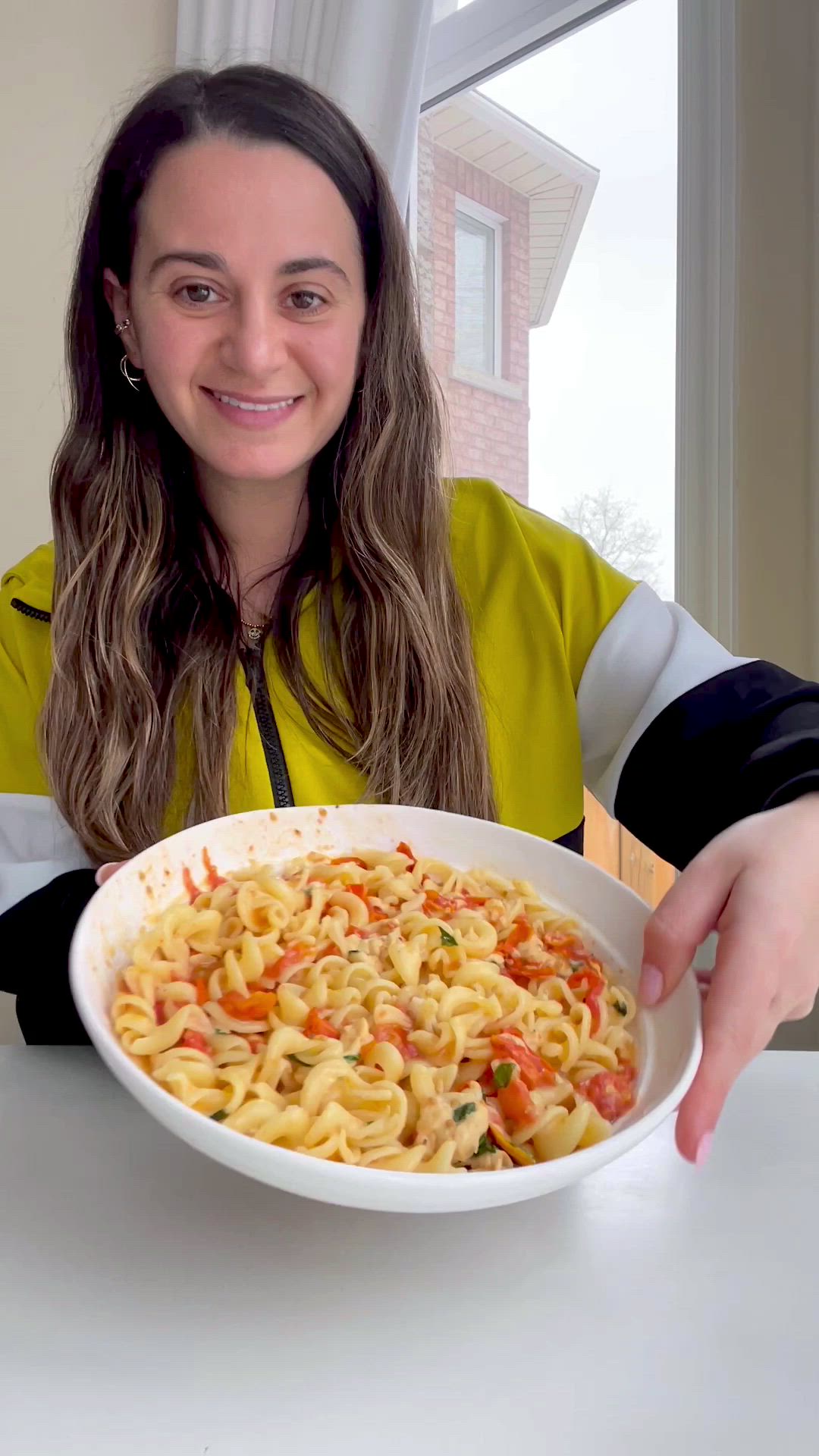 This may contain: a white bowl filled with tomato sauce and cheese