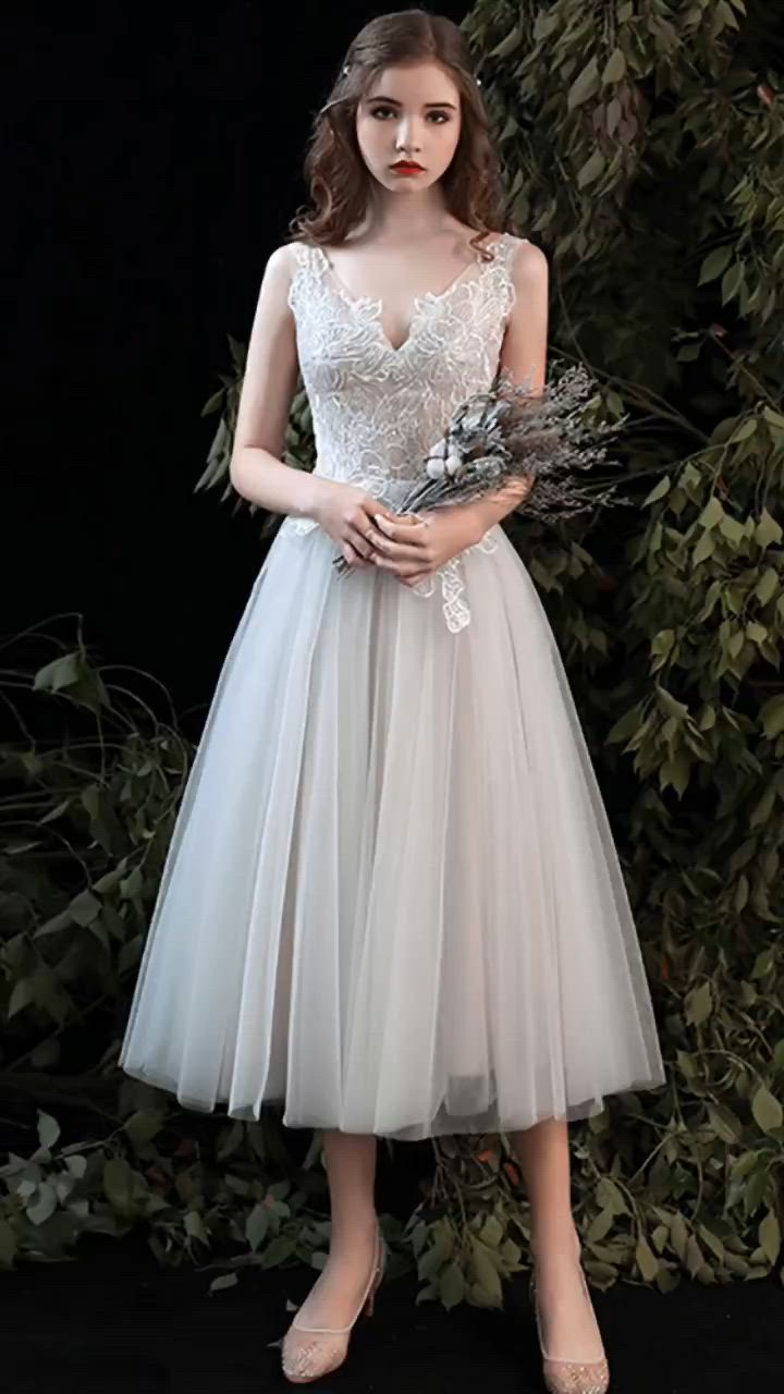 This contains: Beautiful Vneck Lace Aline Tea Length Wedding Dress with Open V Back