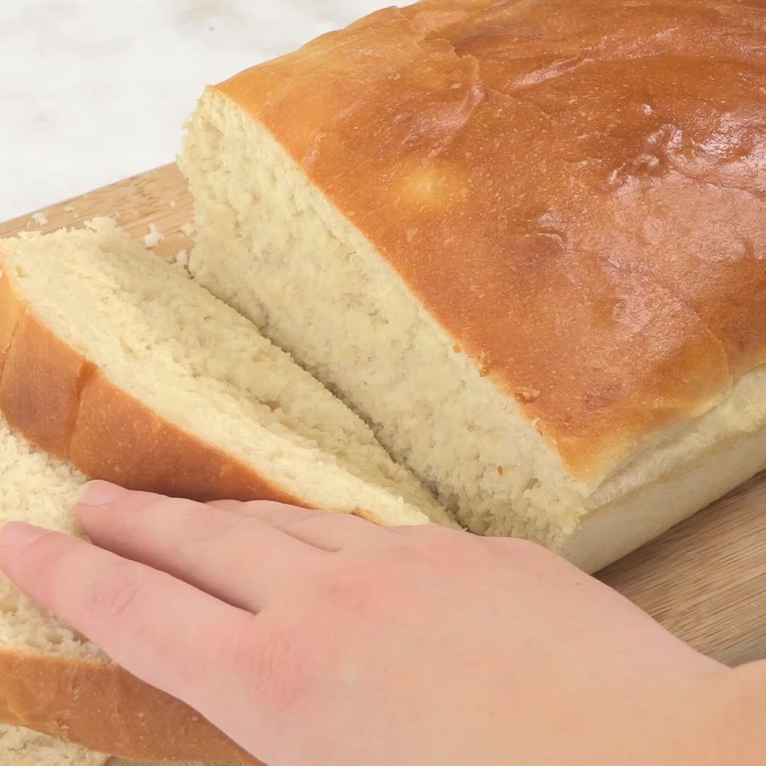 This may contain: a person holding a piece of bread on top of a cutting board with the words follow me @ flavorfizz