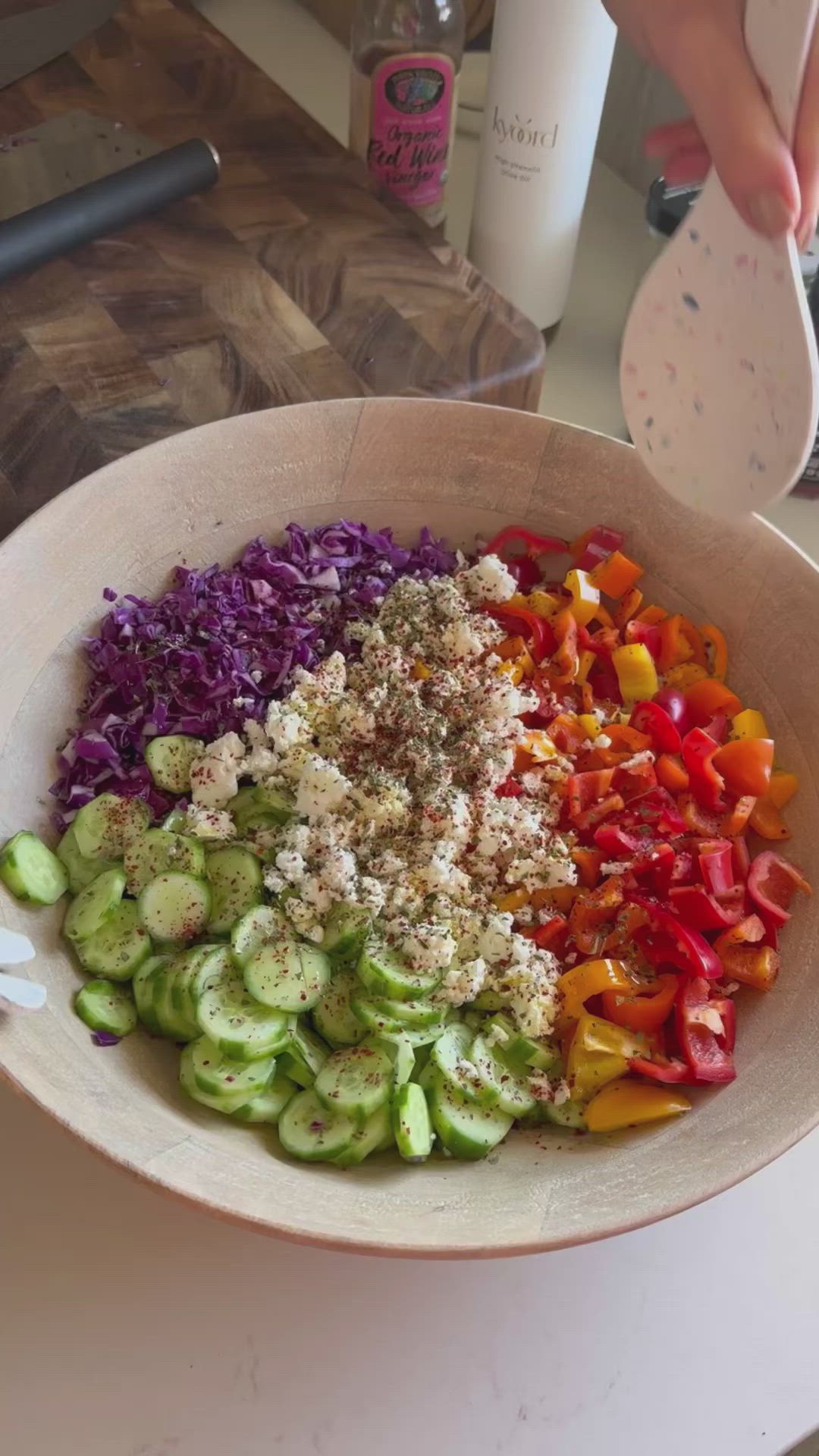 This may contain: a bowl filled with chopped vegetables on top of a table