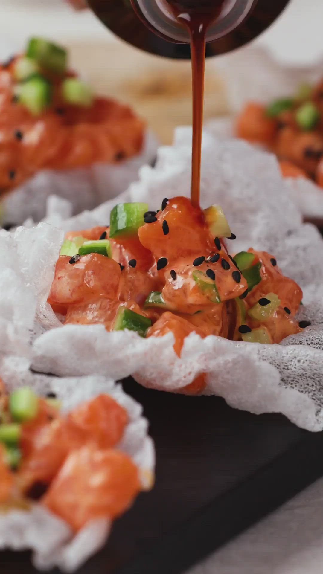 This contains: Spicy Citrus Salmon on Rice Paper Chips