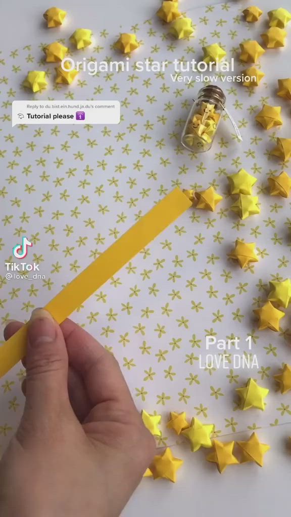 This may contain: a person holding a pencil in front of yellow stars