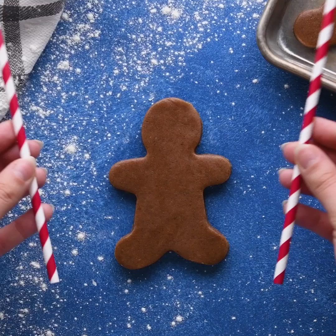 This may contain: gingerbread christmas ornaments hanging from a tree with the words gingerbread wreath on it