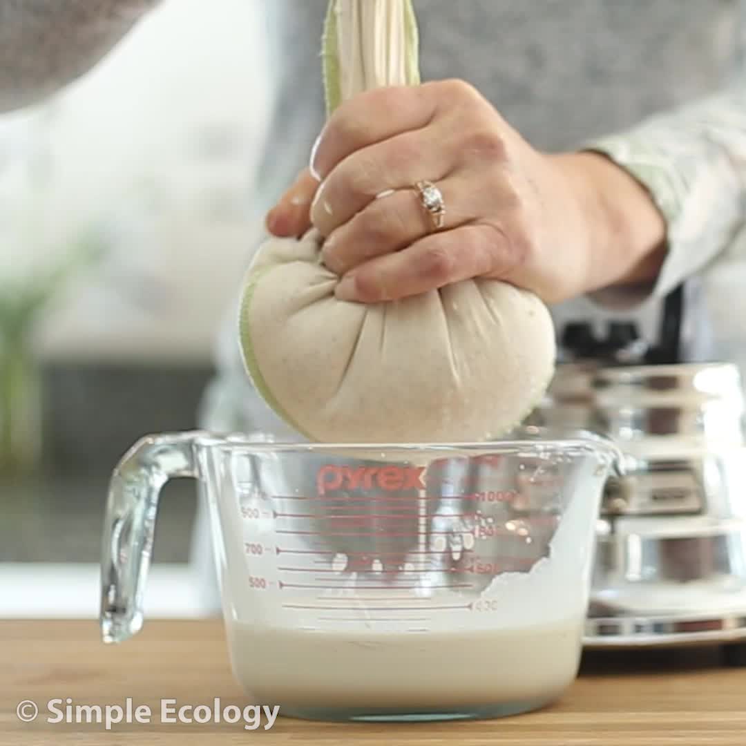 This may contain: someone is adding milk to a blender with the words, homemade almond milk with zero waste