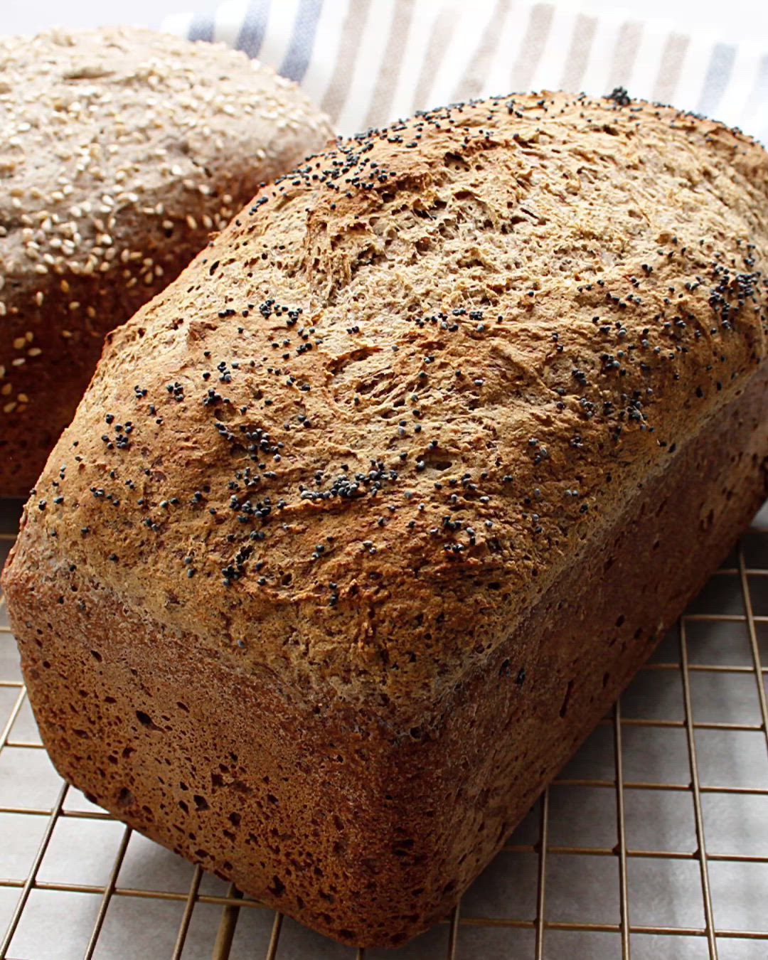 This may contain: two loaves of bread sitting on top of a cooling rack next to each other